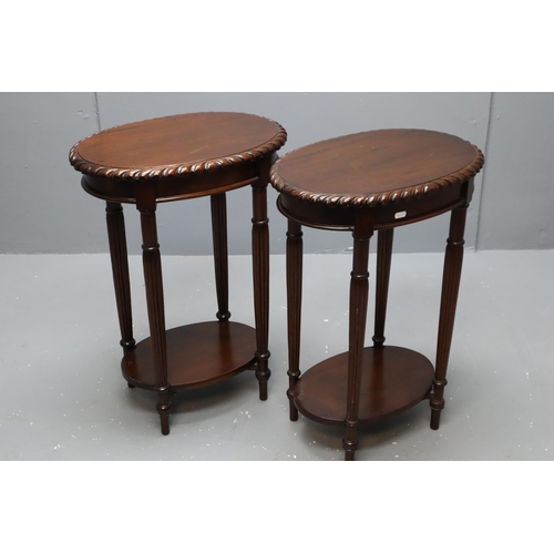 619 - A pair of dark wood wine tables with pie crust edge and storage shelves measuring 27