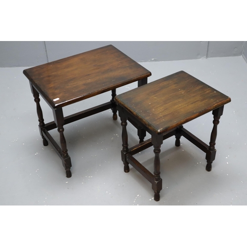 704 - Nest of two tables in dark wood with the biggest being (19