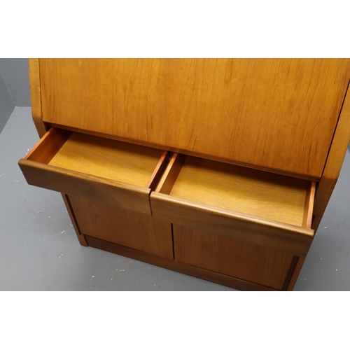 707 - Mid Century Teak Lockable Bureau With Key. Features pigeon holed top section. 2 drawers and a 2 door... 