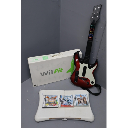 891 - Two Wii fit balance boards (one boxed) and a Wii guitar hero guitar, plus Nitendo DS games (cooking ... 