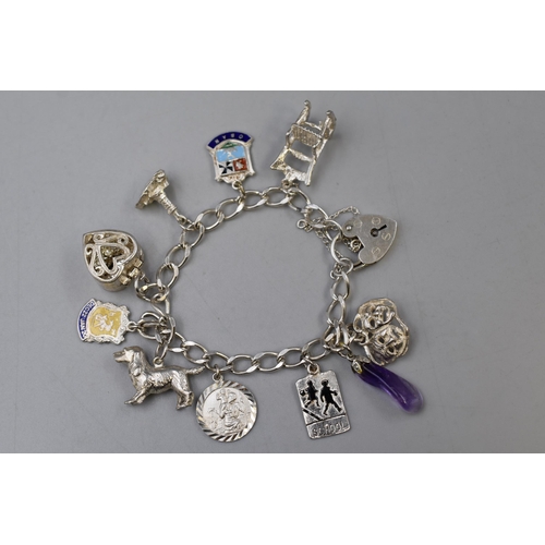 46 - Silver Bracelet with a Selection of 10 Charms