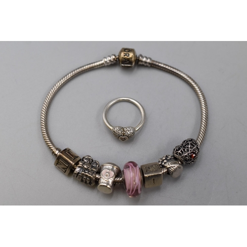 87 - Pandora bracelet with seven charms and a Pandora heart ring (size I)