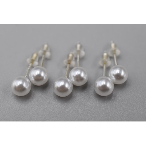 143 - Three pairs of 6mm silver stud white ball earrings