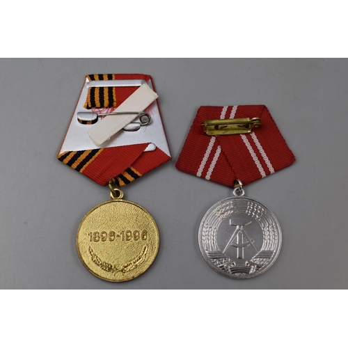 277 - Russian 100th Anniversary Medal for Marshal Xhukov and a East German Medal for Faithful Service both... 