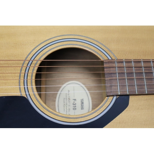 548 - A Yamaha F-310 Acoustic Guitar, With Carry Bag and Accessries (Spare Strings, Strap, And More)