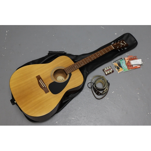 548 - A Yamaha F-310 Acoustic Guitar, With Carry Bag and Accessries (Spare Strings, Strap, And More)