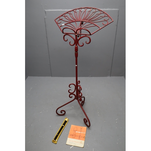 597 - A Heavy Red Cast Iron Music/Book Stand, With Recorder and Sheet Music. Approx 50.5