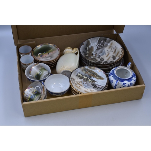 709 - A selection of oriental pottery items to incude cups plates saucers and more