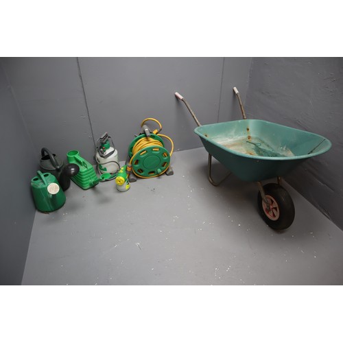 752 - Wheel barrow with two watering cans, hose lock reel hosepipe, weed sprayer and plant feeder