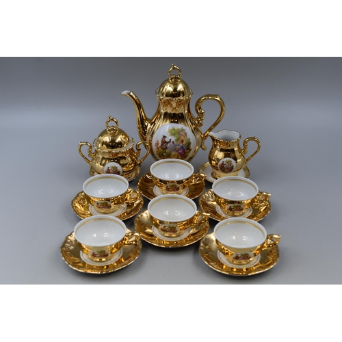 303 - A Fifteen Piece Gold Gilt Bondware Coffee Set Depicting Romantic Scene. Includes Six Cups With Sauce... 