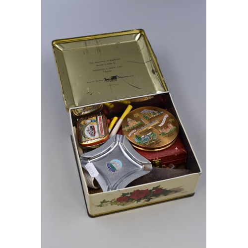 467 - Selection of items in a Meredith & Drew LTD tin to include, a compact mirror, York minister ash ... 