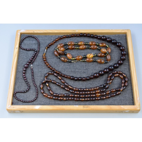 285 - A Selection of Four Faux Amber Beaded Jewellery Necklaces