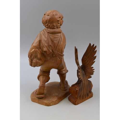 211 - Wood carved American boned eagle and a vintage wood carved figurine carrying a duck (tallest 12