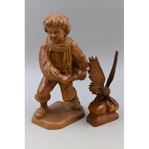 211 - Wood carved American boned eagle and a vintage wood carved figurine carrying a duck (tallest 12