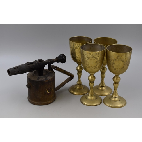 675 - Four brass goblets and a vintage bermous blowtorch