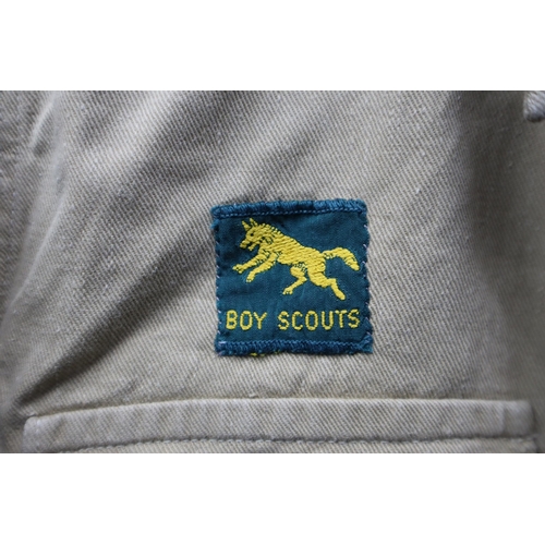 722 - Vintage boy scouts short sleeved shirt with a collection of badges sewed onto it