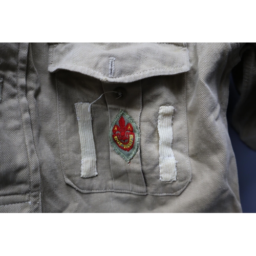 722 - Vintage boy scouts short sleeved shirt with a collection of badges sewed onto it