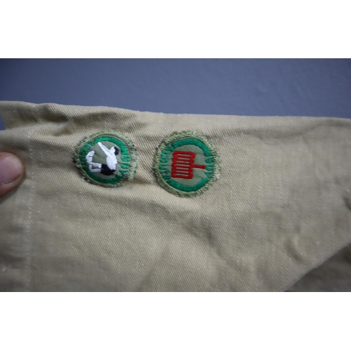 722 - Vintage boy scouts short sleeved shirt with a collection of badges sewed onto it