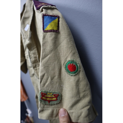 722 - Vintage boy scouts short sleeved shirt with a collection of badges sewed onto it