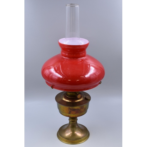 329 - An Aladdin 23 Vintage Brass Oil Lamp, With Red Glass Shade and Chimney. Approx 23.5