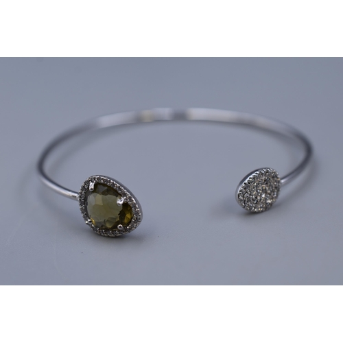 60 - A 925. Silver Clear and Peridot Stoned Bangle