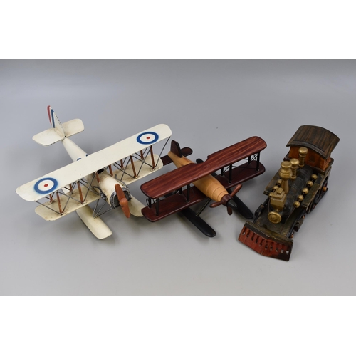 385 - Tin plate model biplane with wooden plane and steam engine