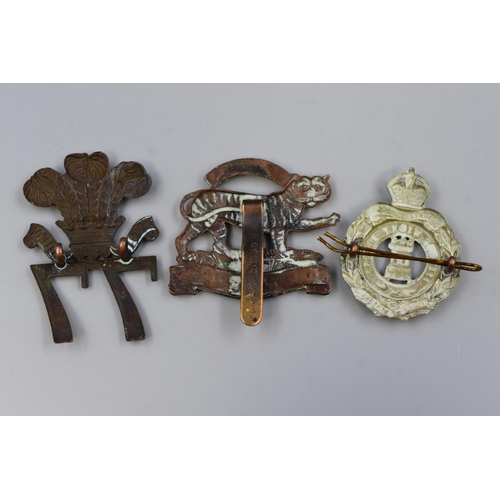 269 - Three Military Cap Badges including Isle Of White Rifles, Royal Leicestershire Regiment, and East Mi... 