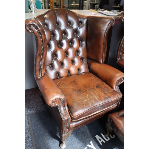 569 - Two Chesterfield Style Brown Leather Wing Backed Studded Arm Chairs with Matching Footstool