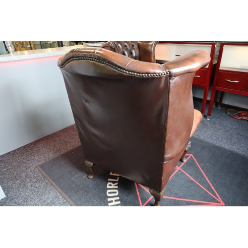 569 - Two Chesterfield Style Brown Leather Wing Backed Studded Arm Chairs with Matching Footstool