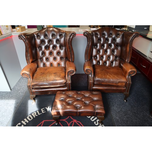 569 - Two Chesterfield Style Brown Leather Wing Backed Studded Arm Chairs with Matching Footstool