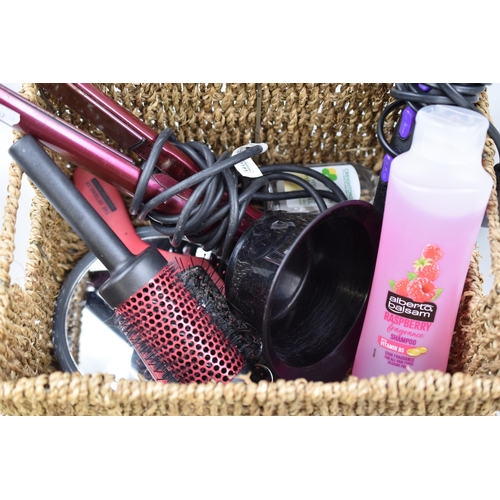 679 - Basket full of hair items to include Straighteners, Hairdryer (working), Brushes, Shampoo and more