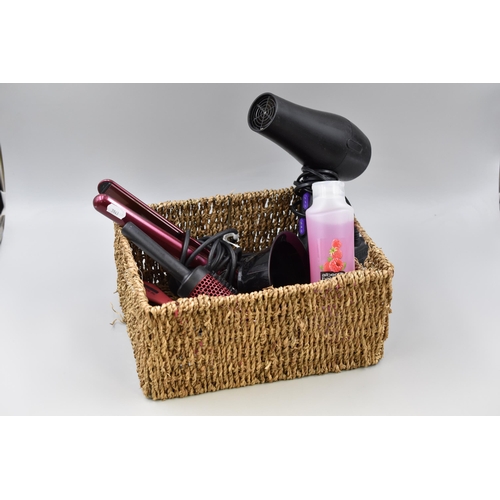 679 - Basket full of hair items to include Straighteners, Hairdryer (working), Brushes, Shampoo and more