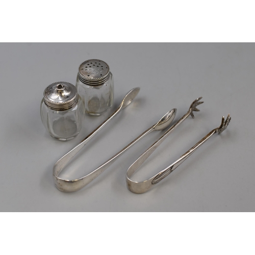 52 - Two Hallmarked Silver Sugar Nips and a Set of Salt and Pepper Pots with Silver Lids