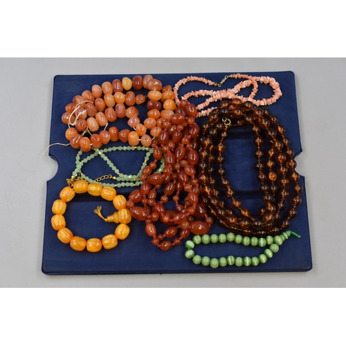 133 - A Selection of Beaded Necklaces and Bracelets, To Include Amber Effect, Jade Style, And More