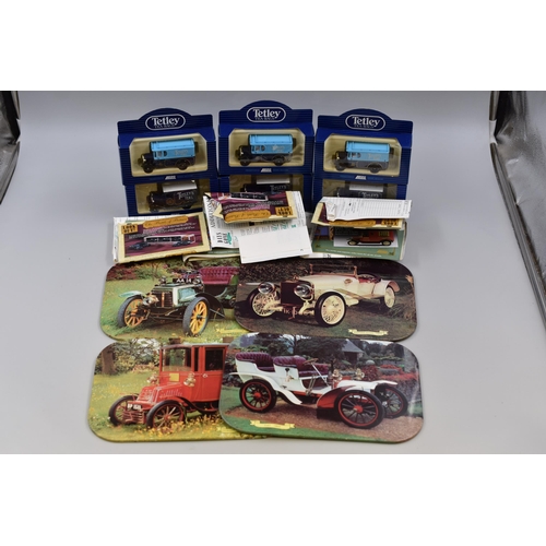 546 - Six Lledo Tetley Tea trucks, never opened still boxed with paperwork and four vintage car place matt... 