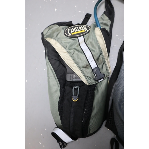 753 - Four Hiking Bags to Include Two Trespass, Camelbak and Reebok with Trespass Thermal Flask