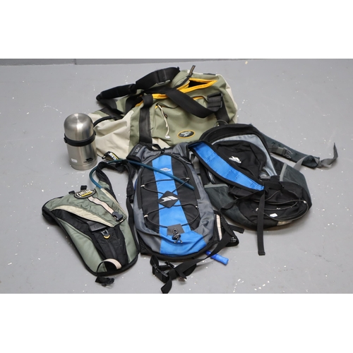 753 - Four Hiking Bags to Include Two Trespass, Camelbak and Reebok with Trespass Thermal Flask