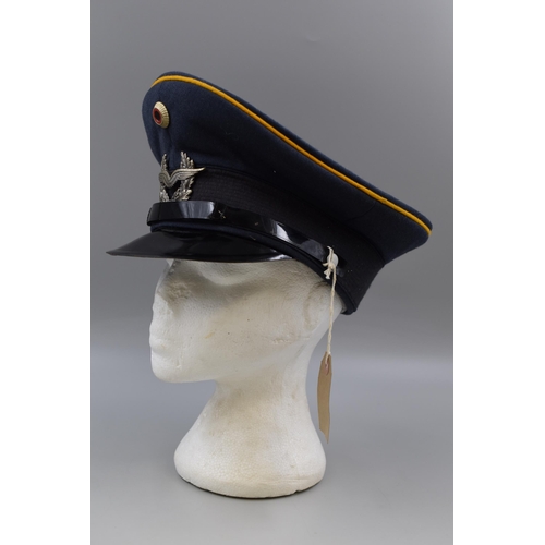 229 - A Post-WW2 period German military cap by Bamberger, size 58, with winged badge and yellow piping