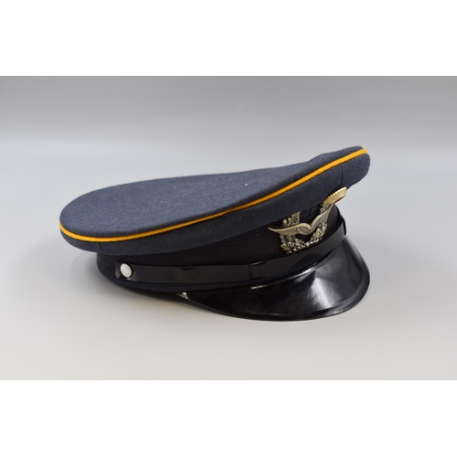 229 - A Post-WW2 period German military cap by Bamberger, size 58, with winged badge and yellow piping