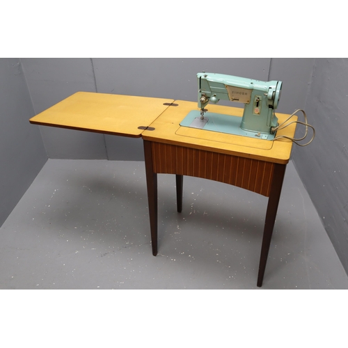 414 - A Vintage Singer 327K Sewing Machine Table, With Instructions and Accessories. Powers On When Tested