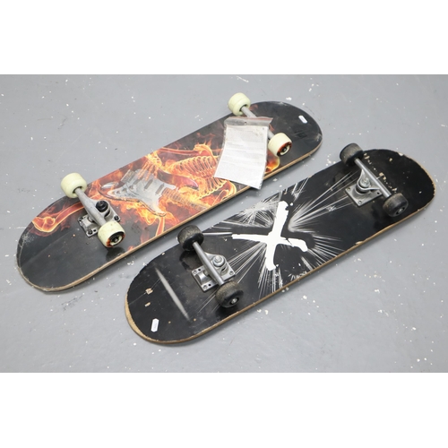 674 - Two Skateboards to Include a Fire Skeleton Playing Guitar and X Styled, One is Still Wrapped in Orig... 