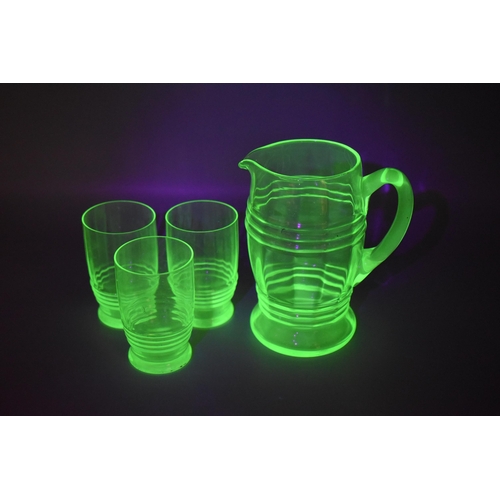 285 - An Art Deco Uranium Glass Jug, With Three Matching Uranium Glass Drinking Glasses. Jug is Approx 7.5... 