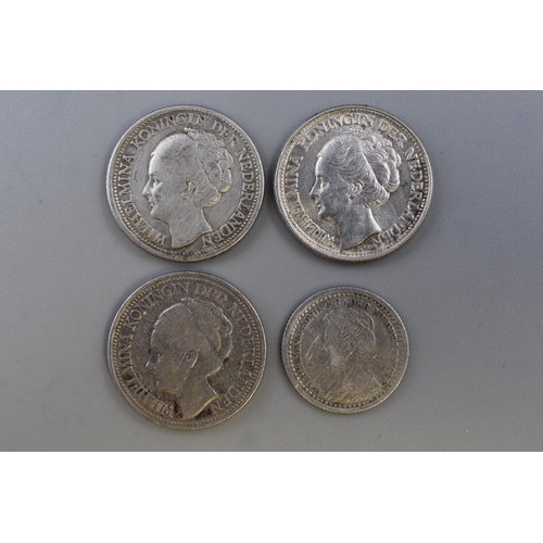 142 - Four Netherlands Silver Coins. Includes Two 25 Cents (1928 and 1944), 1921 10 Cents, And 1944 1/4 Gu... 