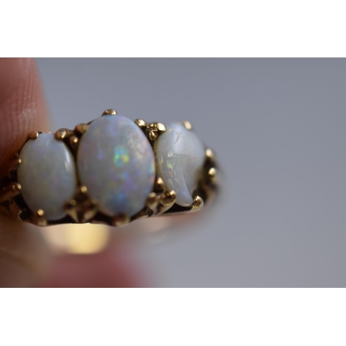 1 - Hallmarked Gold 375 Ring set with Three Opals on Decorative Swirl Mount (one opal a/f) Size K