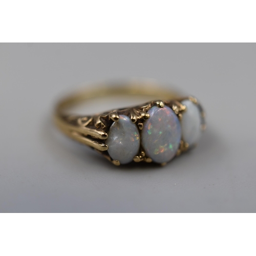 1 - Hallmarked Gold 375 Ring set with Three Opals on Decorative Swirl Mount (one opal a/f) Size K