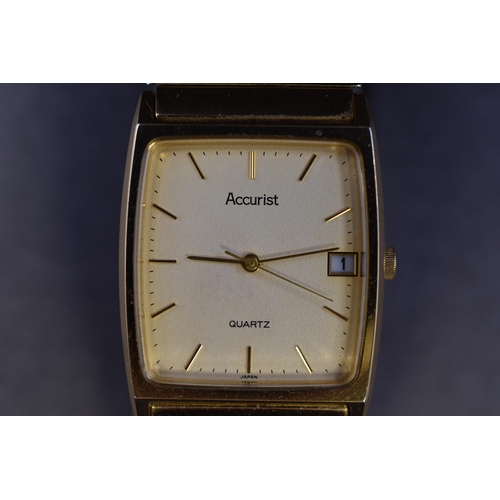 135 - An Accurist Gent's Gold Tone Day/Time Quartz Watch, In Presentation Box. Working