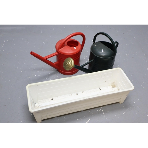 435 - Three garden planters & two plastic watering cans and an outdoor thermometer