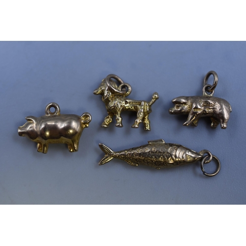 38 - A Selection of Gold 9ct Charms to include Two Pigs, a Dog and a Fish