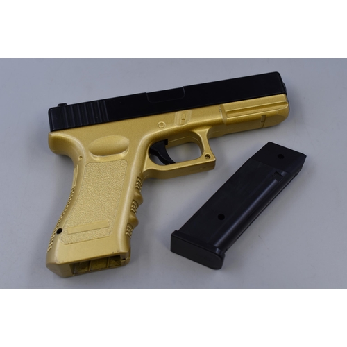 430 - A Black and Gold Spring Loaded BB Gun/Pistol