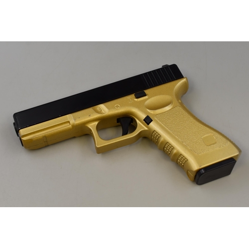 430 - A Black and Gold Spring Loaded BB Gun/Pistol